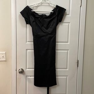 New tags still on black below the knee dress.